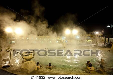 Stock Image - People Enjoying One Of The Outdoor Pools In Szechenyi Baths, Budapest, Hungary. Fotosearch