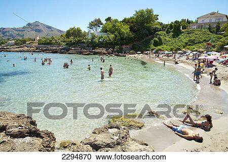 Stock Image - People Enjoying The Summer In Cala Sant Pere, Alcudia, Mallorca, Balearic Islands, Spain. Fotosearch