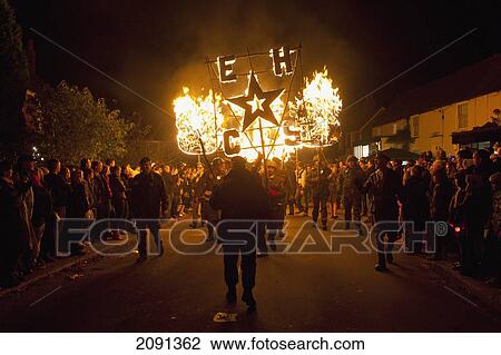People From East Hoathly & Halland Carnival Society Carrying Banner And Burning Poppies Through East Hoathly On Bonfire Night, East Sussex, Uk View Large Photo Image Stock Image - People From East Hoathly & Halland Carnival Society Carrying Banner And Burning Poppies Through East Hoathly On Bonfire Night, East Sussex, Uk. Fotosearch