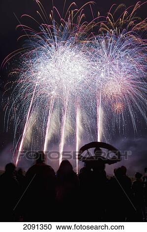 Stock Image - People From Southover Bonfire Society Watch The Fireworks On Bonfire Night, Lewes, East Sussex, Uk. Fotosearch