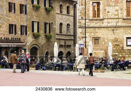 Stock Photograph - People gather in a town square; Montepulciano, Tuscany, Italy. Fotosearch