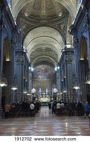 Stock Image - People Gathered In Ferrara Cathedral; Ferrara, Emilia-Romagna, Italy. Fotosearch
