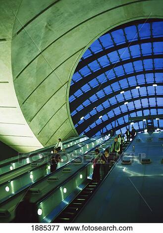 Stock Photo - People Going Up And Down Escalators At The Entrance / Exit To Canary Wharf Station (Architect: Sir Norman Foster), London, Uk.. Fotosearch