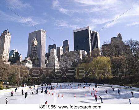 Stock Photography - People Ice Skating On Ice Ring In Central Park. Fotosearch