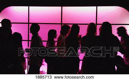 Stock Image - People In Bar Silhouetted By Pink Light. Fotosearch
