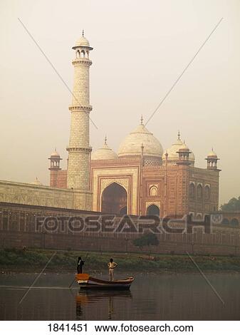 Stock Image - People In Boat In Front Of Taj Mahal; Agra, India. Fotosearch