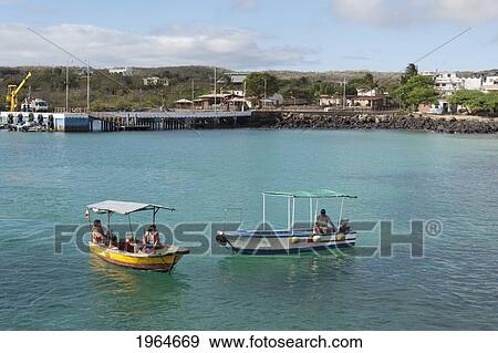 Stock Photo - People In Boats Off The Shore; Puerto Baquerizo Moreno Galapagos Equador. Fotosearch