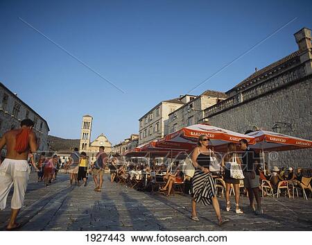 Stock Image - People In Cafes And In The Main Square. Fotosearch
