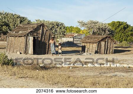 Stock Photograph - People In Front Of Their Homes In Mangily, Toliara Province, Madagascar. Fotosearch