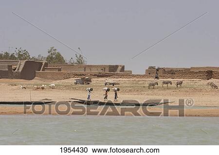 Stock Image - People in pirogues (small boats) fishing in the Niger River between Mopti and Lake Debo, Mali. Fotosearch