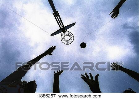 Stock Photo - People In Silhouette Playing Basketball And Looking Up At Basketball Hoop. Fotosearch