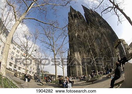 Stock Image - People In Square Near Cologne Cathedral (Kolner Dom), Fish Eye View, Cologne, Germany. Fotosearch