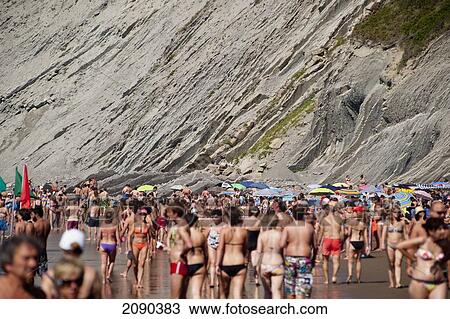 Stock Image - People In Swimwear At Itzurun Beach, Zumaia, Basque Country, Spain. Fotosearch