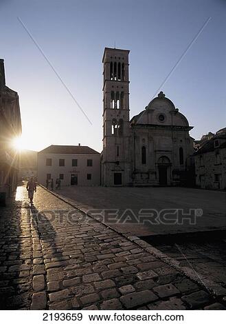 Stock Photo - People In The Main Square In Front Of St. Stephen's Cathedral At Dawn, Hvar Town, Hvar, Croatia.. Fotosearch