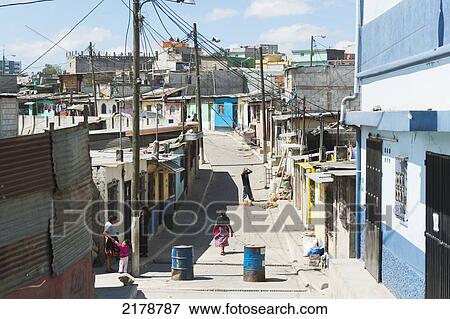 Stock Photo - People In The Street With A View Of A Cityscape; Guatemala City Guatemala. Fotosearch