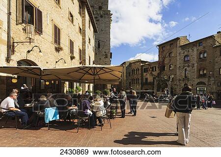 People in the town square; San Gimignano, Tuscany, Italy View Large Photo Image Stock Photo - People in the town square; San Gimignano, Tuscany, Italy. Fotosearch