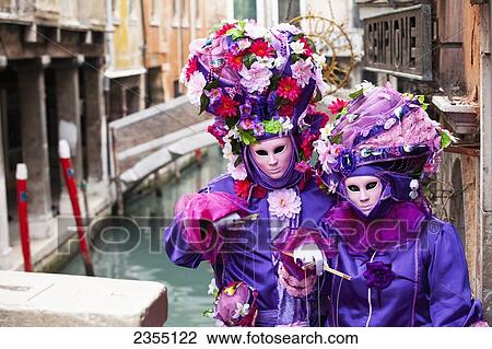 Stock Image - People in Venetian costumes during Venice Carnival; Venice, Italy. Fotosearch