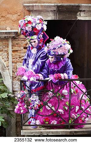 Stock Image - People in Venetian costumes during Venice Carnival; Venice, Italy. Fotosearch