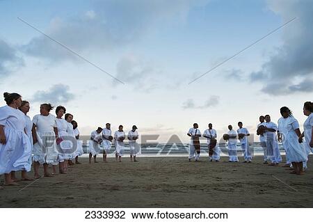 Stock Image - People In White Playing Music On Casino Beach; Rio Grande Do Sul, Brazil. Fotosearch
