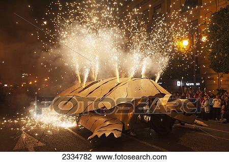 Stock Image - People Inside Metal Turtle Shooting Fireworks During Fallas Festival; Valencia, Spain. Fotosearch