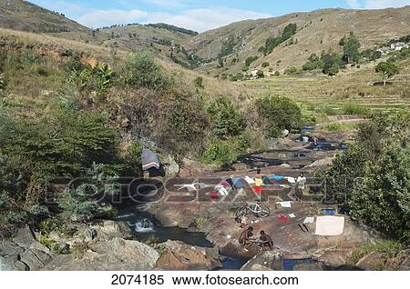 Stock Photography - People Laundering Clothes On A River Along The Road Between Ambositra & Ambavalao, Fianarantsoa Province, Madagascar. Fotosearch