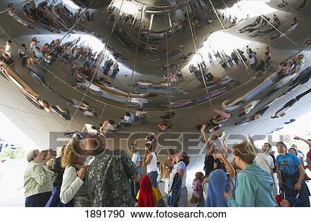 Stock Image - People Looking At Their Reflections In 'cloud Gate' (The Bean) Sculpture At Sbc Plaza. Fotosearch