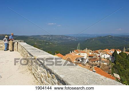 Picture - People Looking At View Of Motovun Rooftops, Istria, Croatia. Fotosearch