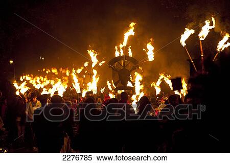 Stock Photography - People marching along road for the East Hoathly Bonfire night; East Sussex, England. Fotosearch