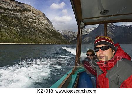 Stock Photo - People On A Boat Tour On Lake Minnewanka, Banff National Park, Alberta, Canada. Fotosearch