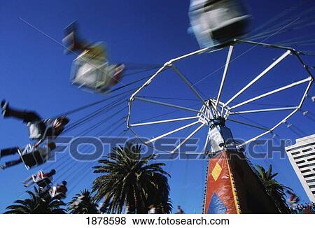 People On A Flying Swings Ride At A Funfair, Blurred Motion View Large Photo Image Stock Photo - People On A Flying Swings Ride At A Funfair, Blurred Motion. Fotosearch