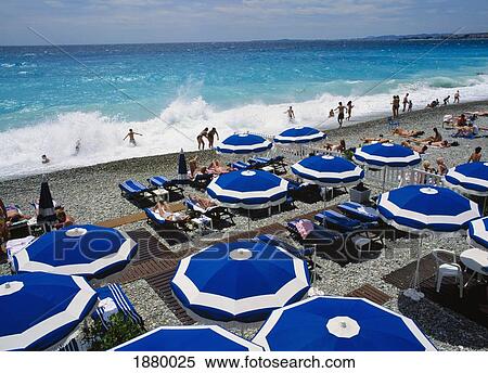 Stock Photography - People On Beach With Umbrellas, Elevated View. Fotosearch