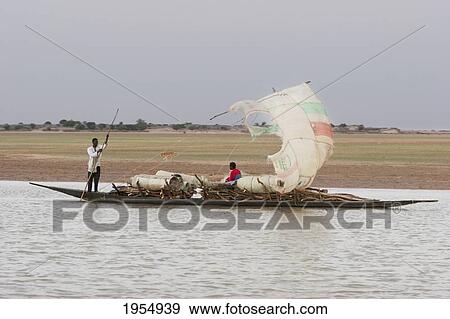 Stock Photo - People on sail boat at the Niger River between Lake Debo and Sebi, Mali. Fotosearch