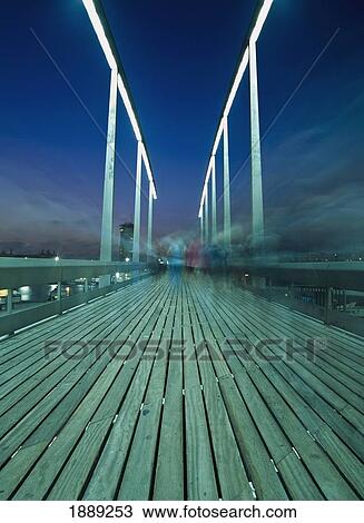 People On Swing Bridge At Dusk, Blurred Motion View Large Photo Image Stock Image - People On Swing Bridge At Dusk, Blurred Motion. Fotosearch