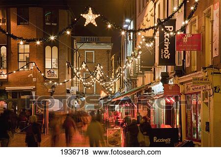 Stock Photo - People On The Sidewalk Outside Restaurants And Shops; Cork City County Cork Ireland. Fotosearch