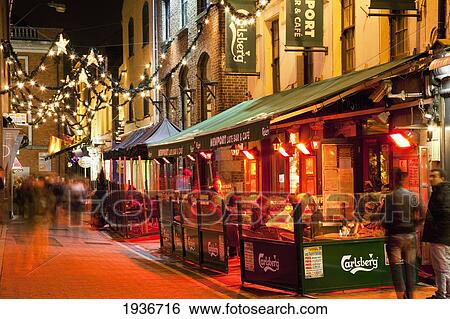 Stock Photograph - People On The Sidewalk Outside Restaurants And Shops; Cork City County Cork Ireland. Fotosearch