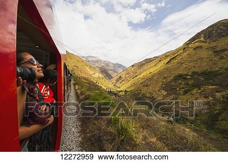 People on the viewing platform of the Observation car of the Tren Crucero train, Nariz del Diablo (Devil's Nose), Chimborazo, Ecuador View Large Photo Image Stock Photo - People on the viewing platform of the Observation car of the Tren Crucero train, Nariz del Diablo (Devil's Nose), Chimborazo, Ecuador. Fotosearch