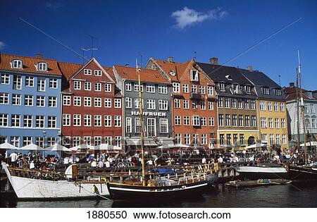 Stock Image - People On Waterfront In Nyhaven. Fotosearch