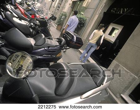 Stock Photography - People Outside Chanel Shop And Parked Scooters, Milan Italy. Fotosearch
