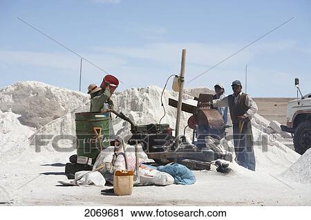 Stock Image - People Packaging Salt From The Salar De Uyuni In The Village Of Colchani, Potosi Department, Bolivia. Fotosearch