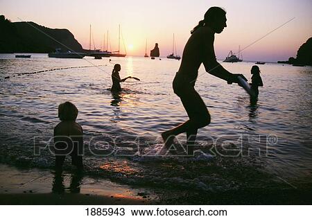 People Playing Frisbee In The Water At Sunset At Benirras Beach View Large Photo Image Stock Image - People Playing Frisbee In The Water At Sunset At Benirras Beach. Fotosearch