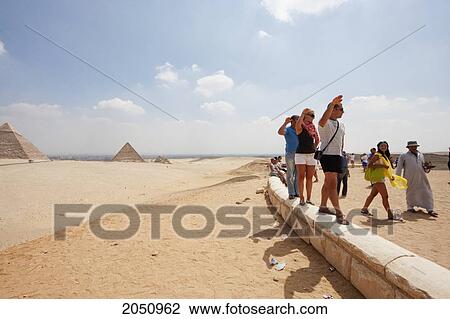 People Posing In Front Of The Pyramids, Giza, Al Jizah, Egypt View Large Photo Image Stock Image - People Posing In Front Of The Pyramids, Giza, Al Jizah, Egypt. Fotosearch