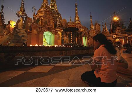Stock Photo - People praying at Shwedagon Pagoda; Yangon, Burma. Fotosearch