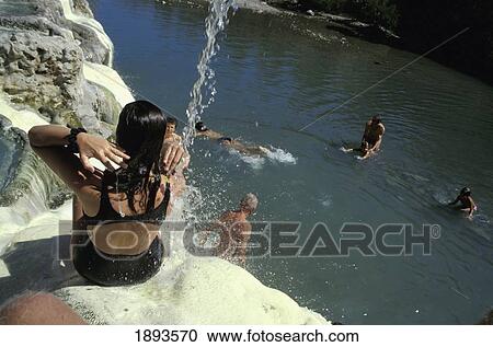 Stock Image - People Relaxing In Thermal Sulphurous Spa, Fosso Biano (Bagni San Filippo). Fotosearch