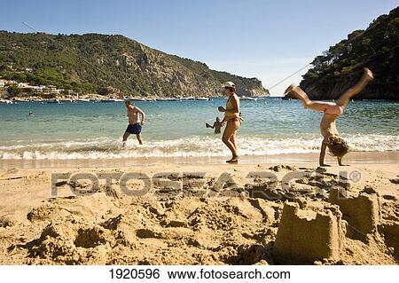 Stock Photograph - People Relaxing On Begur Beach. Fotosearch
