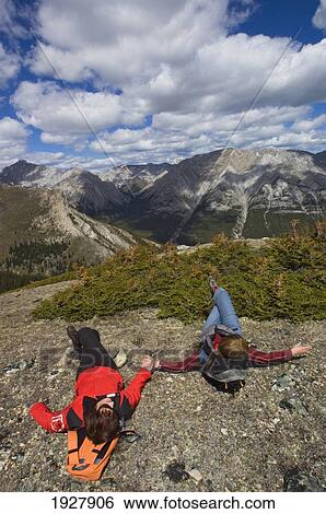 Stock Photograph - People Resting On Rock, Elevated View, Alberta, Canada. Fotosearch