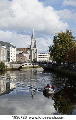Stock Photograph - People Riding In A Boat Down River Lee; Cork City County Cork Ireland. Fotosearch