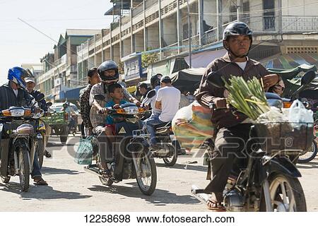 People riding motorbikes around Old Market; Battambang, Cambodia View Large Photo Image Stock Photo - People riding motorbikes around Old Market; Battambang, Cambodia. Fotosearch