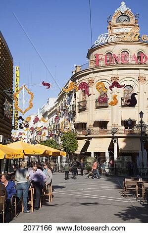 People Sitting At Tables Under Umbrellas Under A Busy Town Square; Jerez De La Frontera Andalusia Spain View Large Photo Image Stock Photograph - People Sitting At Tables Under Umbrellas Under A Busy Town Square; Jerez De La Frontera Andalusia Spain. Fotosearch