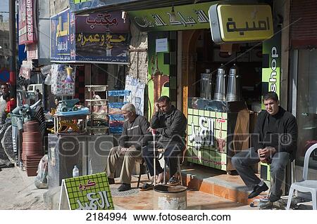 Picture - People Sitting In Front Of Stores, Jordan, Middle East. Fotosearch