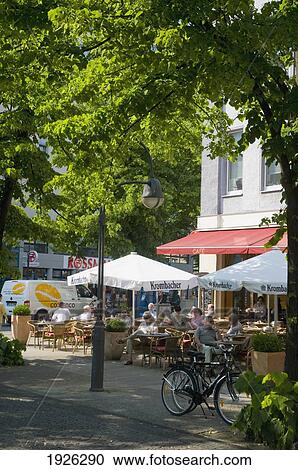 Stock Image - People Sitting In Outdoor Cafe. Fotosearch